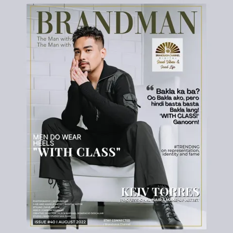 Cover-style graphic titled BRANDMAN on a pale background: a man in black clothing and heeled boots seated on a white chair.